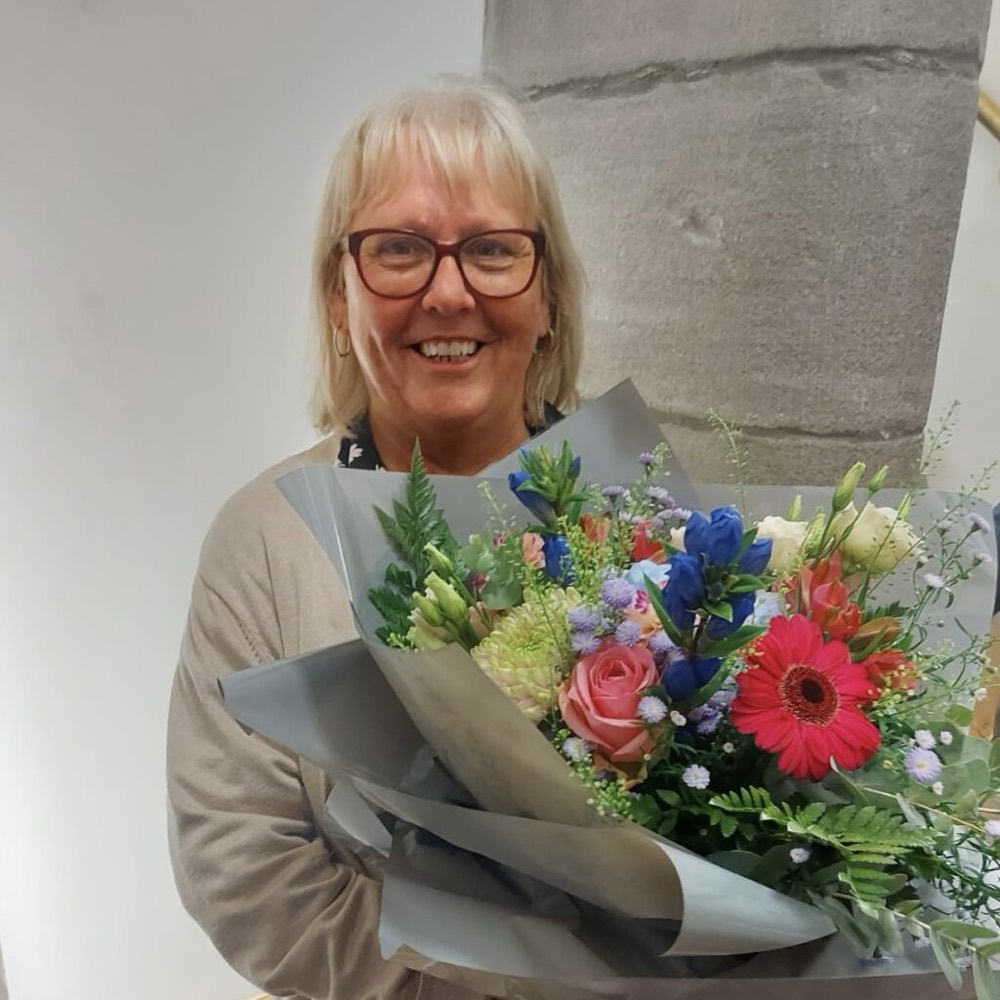 Mary Sneddon from The Board steps down and has been given a beautiful bunch of flowers.
