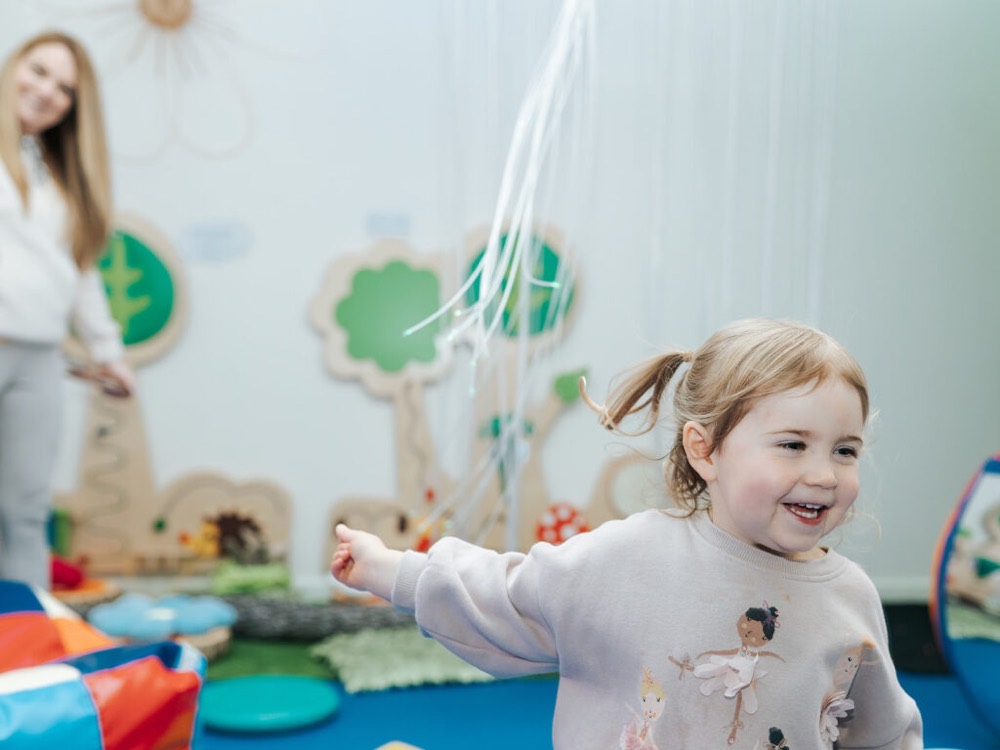 The Circle CIC More Than Profit social enterprise Social Impact Report 2021/22. The image shows a child playing in the sensory hub in the circle Glasgow.
